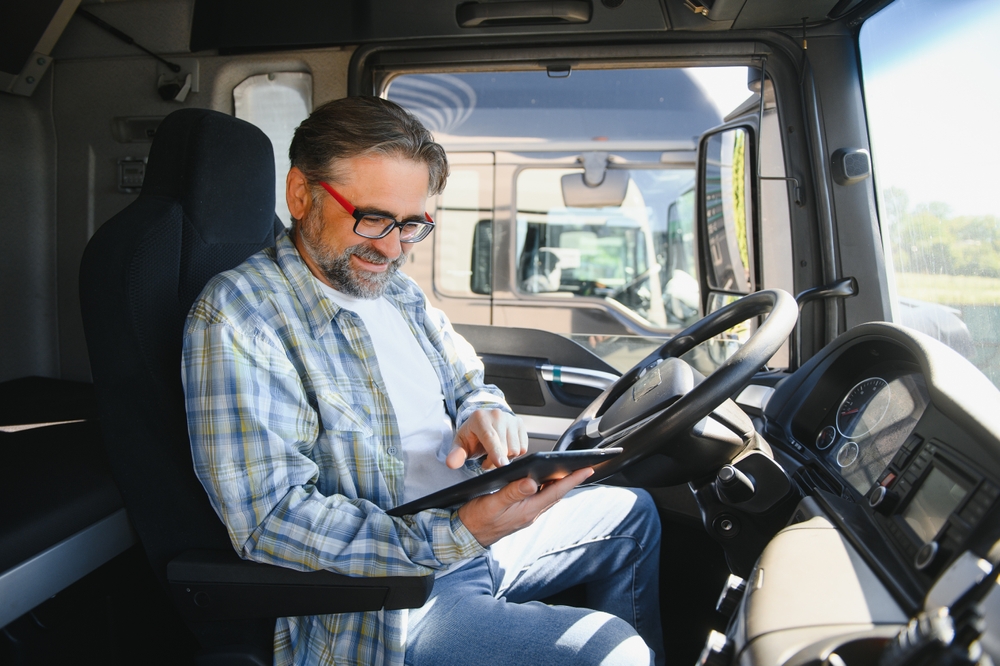 Truck driver using a tablet to look up DOT violation information